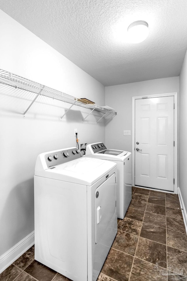 11532 Aruba Dr, Pensacola, FL 32506 - laundry area featuring baseboards, laundry area, a textured ceiling, and washer and clothes dryer