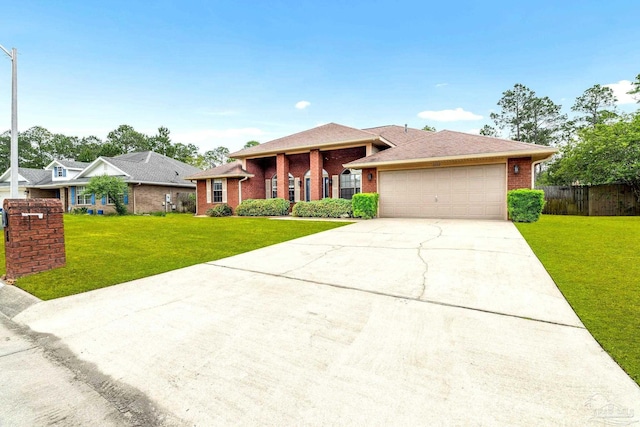 11532 Aruba Dr, Pensacola, FL 32506 - view of front facade featuring an attached garage, a front lawn, brick siding, and concrete driveway