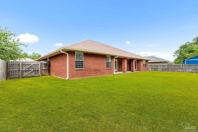 11532 Aruba Dr, Pensacola, FL 32506 - back of house featuring a lawn, brick siding, and a fenced backyard