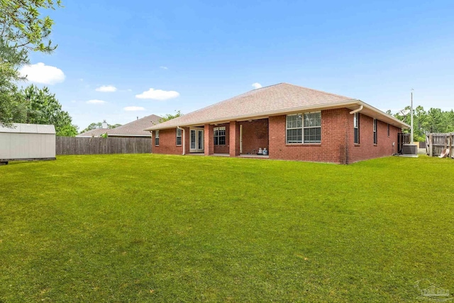 11532 Aruba Dr, Pensacola, FL 32506 - back of house with a lawn, a fenced backyard, central AC, and brick siding
