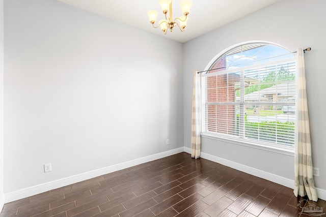 11532 Aruba Dr, Pensacola, FL 32506 - unfurnished room with an inviting chandelier, baseboards, and dark wood-style flooring