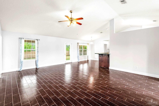 11532 Aruba Dr, Pensacola, FL 32506 - unfurnished living room featuring baseboards, ceiling fan, a healthy amount of sunlight, and lofted ceiling