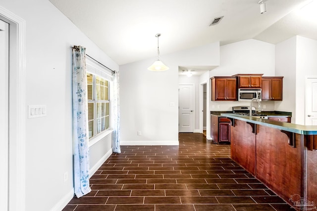 11532 Aruba Dr, Pensacola, FL 32506 - kitchen with a breakfast bar area, stainless steel appliances, baseboards, and lofted ceiling