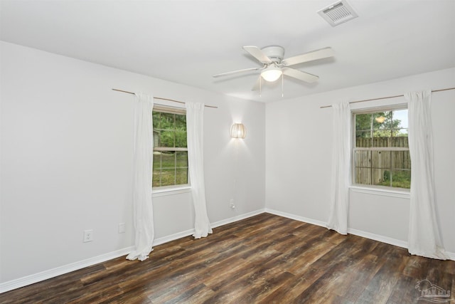 spare room featuring ceiling fan and dark wood-type flooring