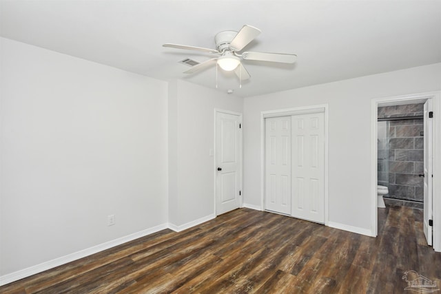 unfurnished bedroom featuring dark hardwood / wood-style flooring, a closet, ceiling fan, and connected bathroom