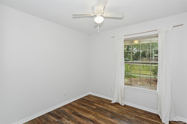 empty room with ceiling fan and dark hardwood / wood-style flooring