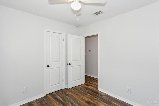 unfurnished bedroom with dark hardwood / wood-style flooring and ceiling fan