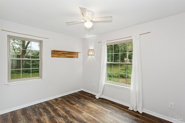 spare room with ceiling fan, plenty of natural light, and dark hardwood / wood-style floors