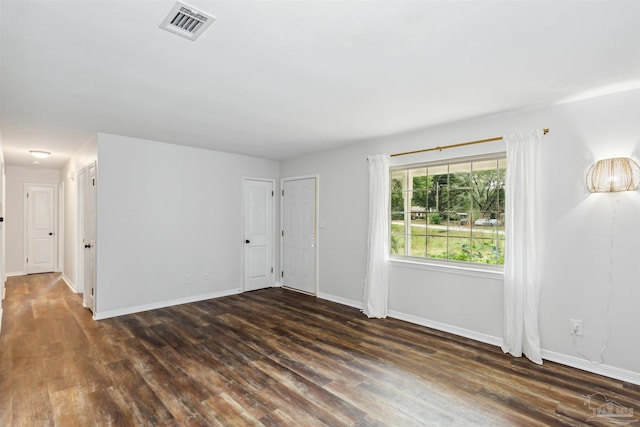 spare room featuring dark wood-type flooring