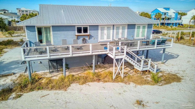 rear view of property with a wooden deck and french doors