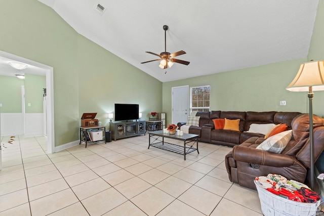 living room featuring high vaulted ceiling, light tile patterned floors, visible vents, and a ceiling fan