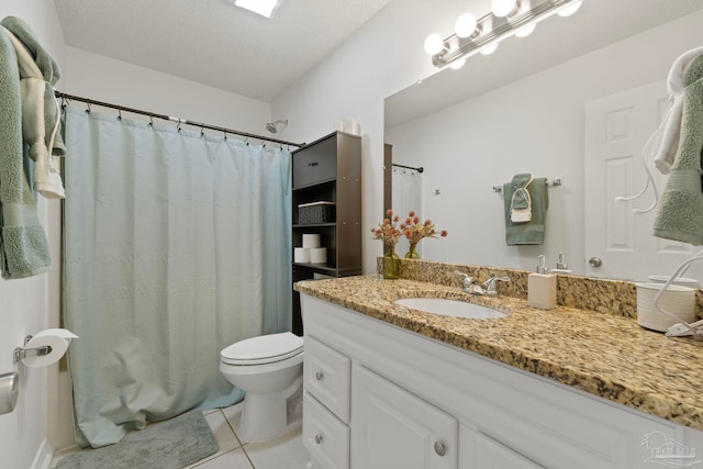 bathroom featuring toilet, a textured ceiling, tile patterned flooring, and vanity