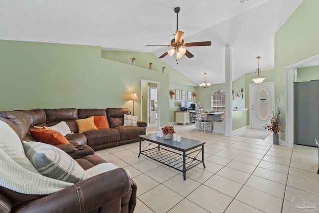 living area with baseboards, lofted ceiling, light tile patterned flooring, a textured ceiling, and ceiling fan with notable chandelier