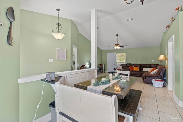 dining room featuring lofted ceiling, ceiling fan, baseboards, and light tile patterned floors