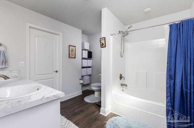 full bathroom featuring toilet, shower / bath combo with shower curtain, vanity, and hardwood / wood-style flooring