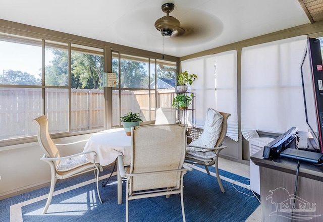 sunroom / solarium featuring ceiling fan