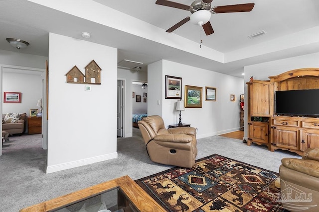 living room with light colored carpet and ceiling fan