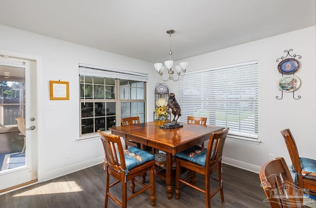 dining area featuring dark hardwood / wood-style floors, a chandelier, and plenty of natural light