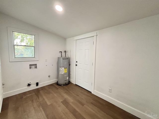 clothes washing area with laundry area, electric water heater, baseboards, and wood finished floors