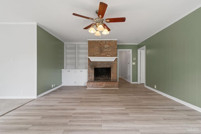 unfurnished living room with a brick fireplace, light hardwood / wood-style floors, ceiling fan, and built in features