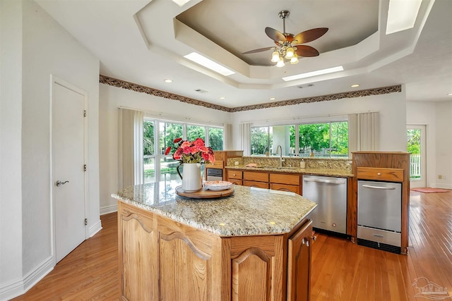 7208 Bayshore Dr, Milton, FL 32583 - kitchen with dishwasher, a raised ceiling, a sink, light wood finished floors, and recessed lighting