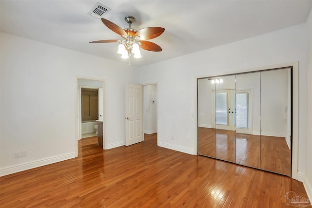 7208 Bayshore Dr, Milton, FL 32583 - unfurnished bedroom featuring light wood-style flooring, baseboards, a closet, and ceiling fan