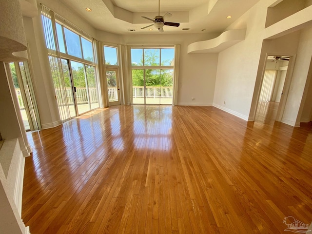 7208 Bayshore Dr, Milton, FL 32583 - empty room with a ceiling fan, hardwood / wood-style flooring, baseboards, a raised ceiling, and recessed lighting