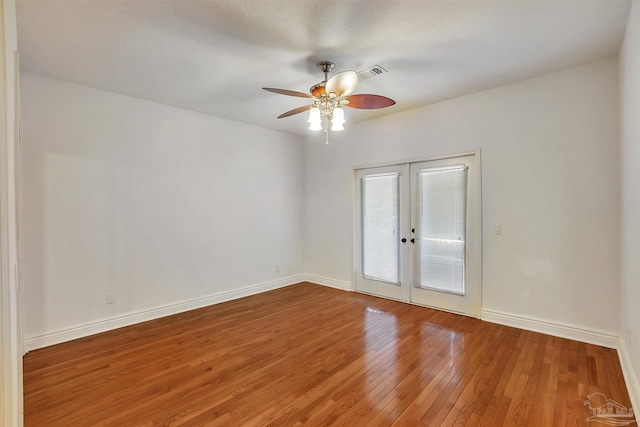 7208 Bayshore Dr, Milton, FL 32583 - empty room featuring french doors, a ceiling fan, hardwood / wood-style floors, and baseboards
