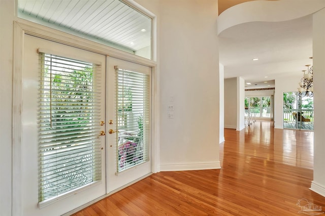7208 Bayshore Dr, Milton, FL 32583 - doorway featuring wood finished floors, a chandelier, french doors, arched walkways, and recessed lighting