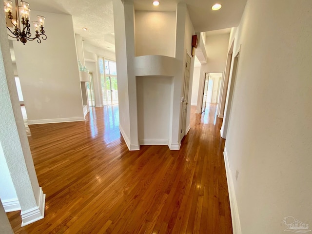7208 Bayshore Dr, Milton, FL 32583 - corridor with dark wood-type flooring, baseboards, a chandelier, and recessed lighting