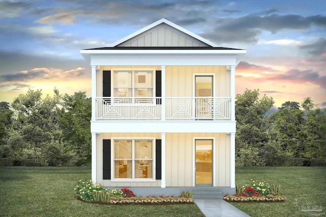 back house at dusk featuring a yard and a balcony