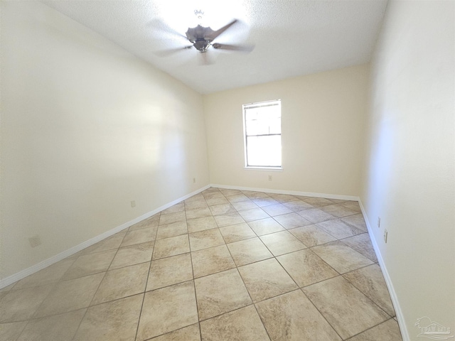 tiled spare room featuring a textured ceiling and ceiling fan