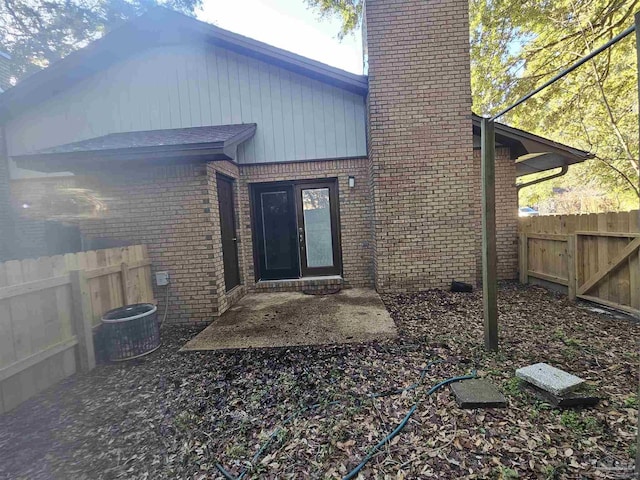 back of property with a patio