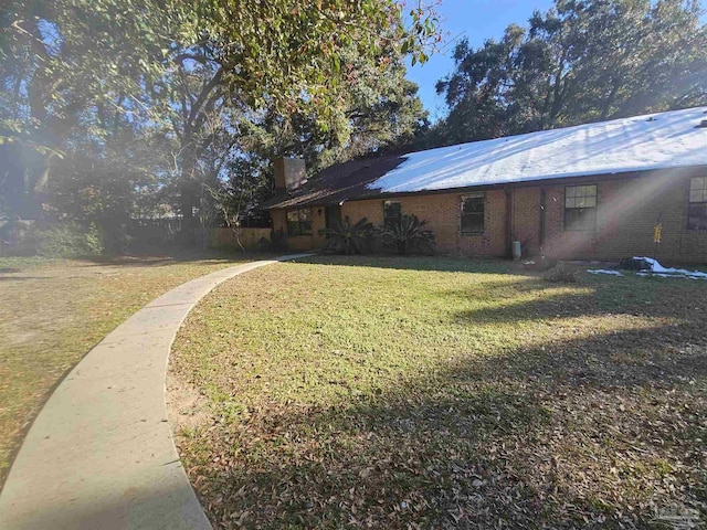 view of side of property with a lawn