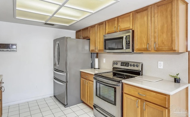 kitchen with light tile patterned flooring and appliances with stainless steel finishes