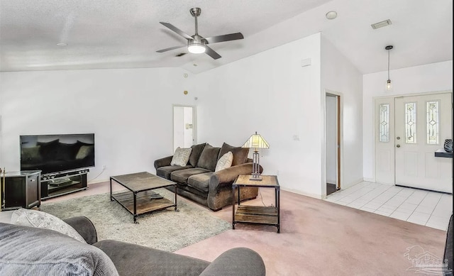 living room featuring ceiling fan, lofted ceiling, a textured ceiling, and light tile patterned floors