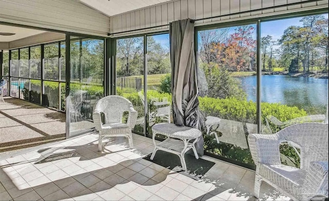 sunroom / solarium featuring a water view and lofted ceiling