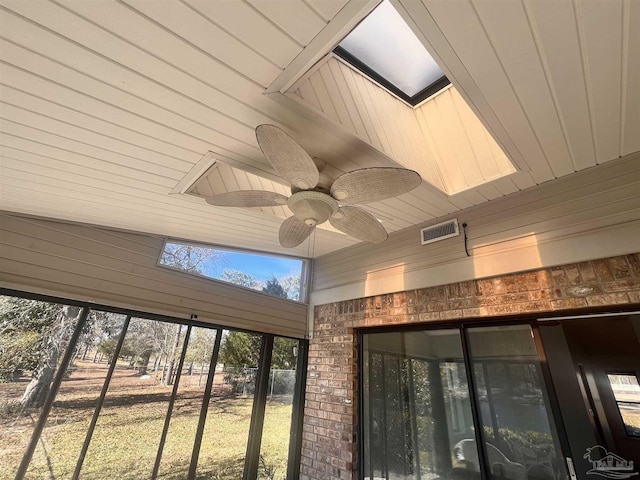 room details featuring ceiling fan and wooden walls