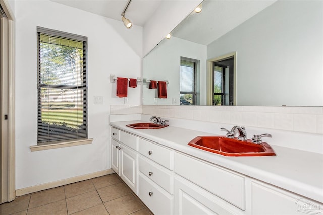 bathroom featuring tile patterned flooring, vanity, and vaulted ceiling