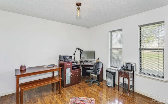 office space featuring a textured ceiling and dark wood-type flooring