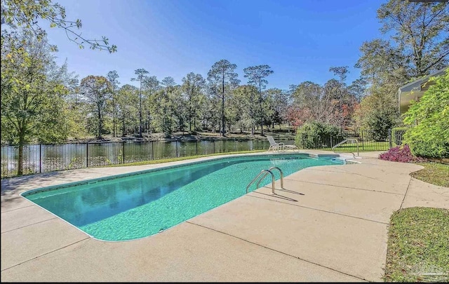 view of pool with a water view and a patio area