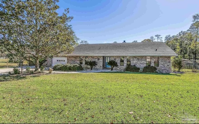 ranch-style home featuring a garage and a front yard