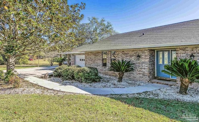 view of home's exterior with a lawn and a garage