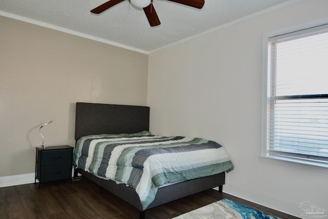 bedroom featuring a textured ceiling, dark hardwood / wood-style floors, ceiling fan, and crown molding