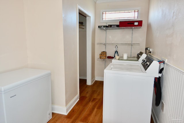 laundry area with hardwood / wood-style flooring and separate washer and dryer