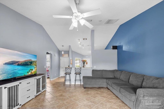 tiled living room with vaulted ceiling and ceiling fan