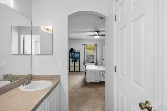 bathroom featuring vanity, a textured ceiling, and ceiling fan