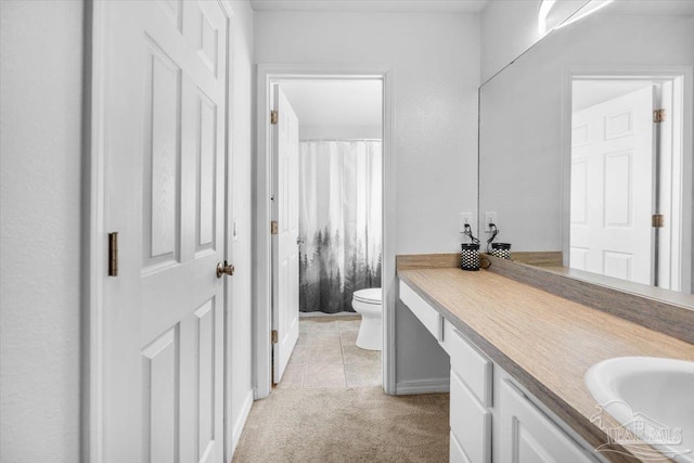 bathroom featuring vanity, toilet, and tile patterned floors