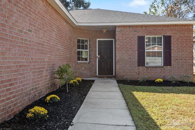 entrance to property featuring a yard