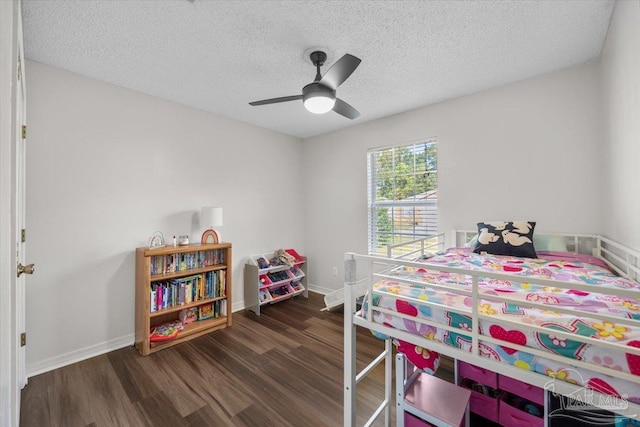 bedroom featuring a textured ceiling, dark wood-type flooring, and ceiling fan